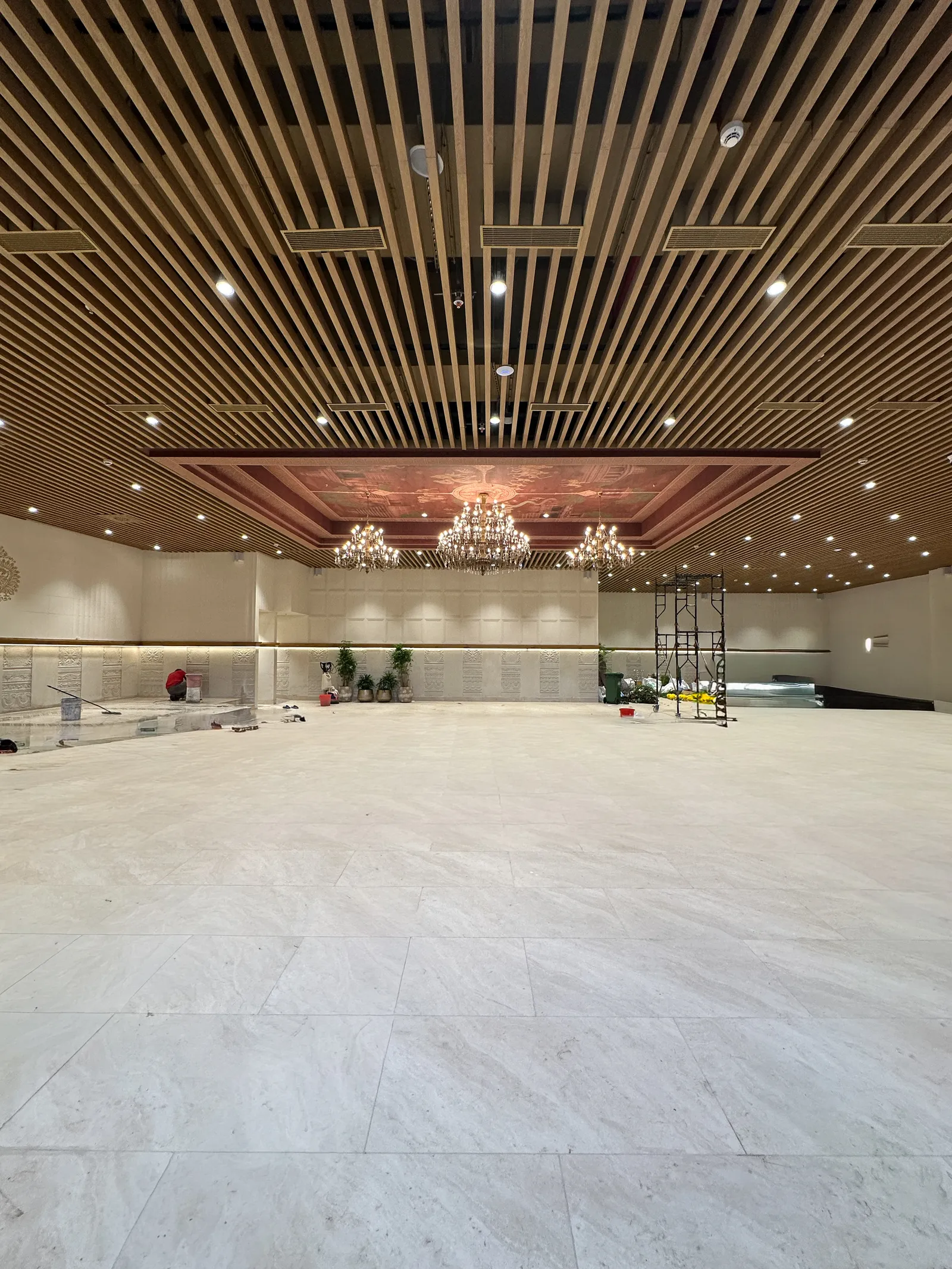 Banquet hall with timber-slat ceiling under construction finish — Chalukya Samrat